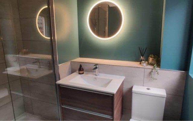 02 - Splash Kitchens & Bathrooms - Bathroom featuring a Round LED Mirror, Vanity Unit and Toilet